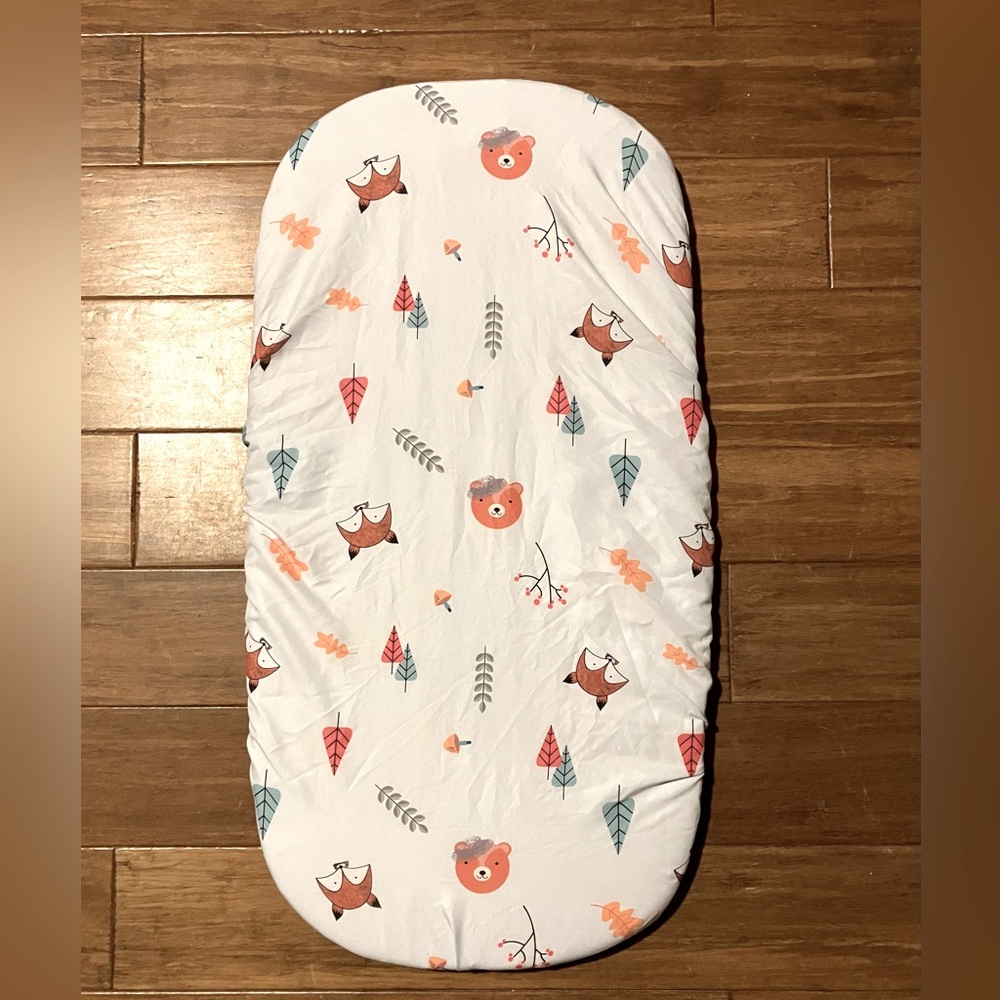 Two woodlands bassinet mattress covers for baby.